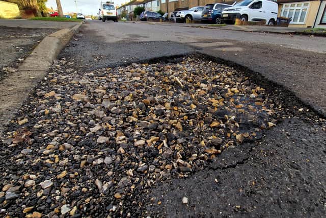 The potholes in Monks Close, Lancing (pictured before the latest repair works). Photo SR staff/Nationalworld / SR23121101
