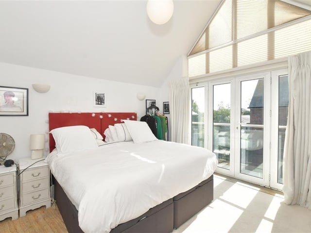 The double doors lead out onto the sunny balcony.