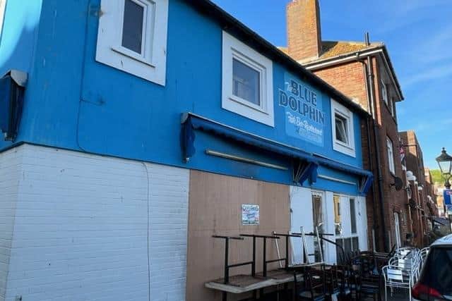The Blue Dolphin showing the boarded up window