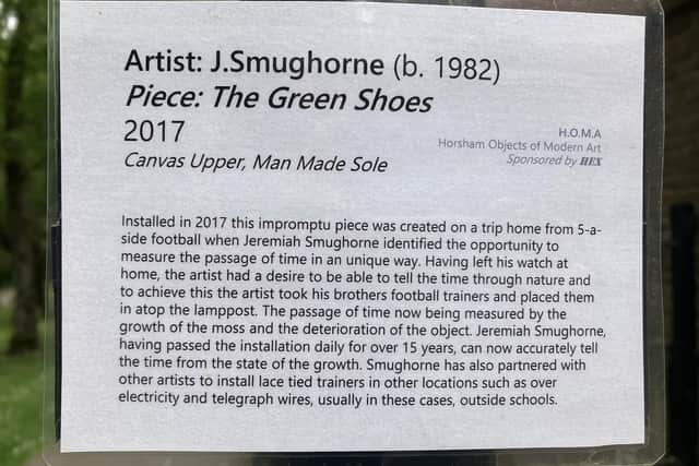 The mystery curator's art appreciation card of the decaying shoes on the top of a lamppost by Sainsbury's in Horsham