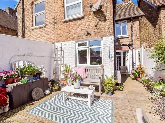The decked area of the garden has enough space for a table and chairs