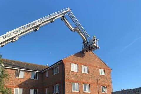 The fire service removing the tiles
