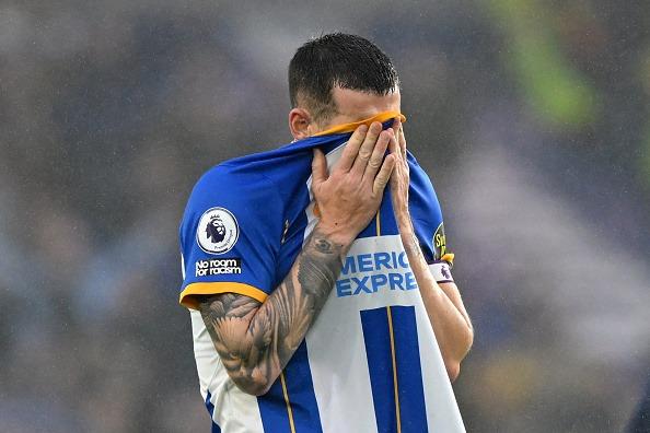 Brighton defender Lewis Dunk reacts to their defeat on the pitch against Everton