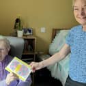 Norden House resident, Sister Anne Marie, with staff member Angie and the Easter card