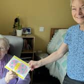 Norden House resident, Sister Anne Marie, with staff member Angie and the Easter card