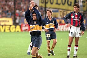 Argentina's former World Cup superstar Diego Maradona greets Boca Juniors fans in Buenos Aires after play had stopped during the Boca Juniors' match against San Lorenzo in a local tournament. (Photo DANIEL LUNA/AFP via Getty Images)