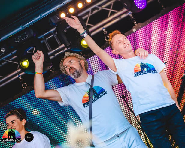 Stuart Burrows (right) with husband Jonny on stage at Chichester Pride 2023. Credit Kirsty Jayne Russell