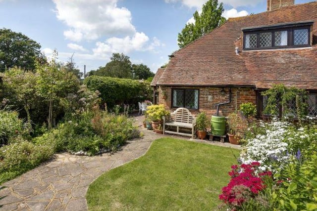 The property is surrounded by well cared for cottage gardens