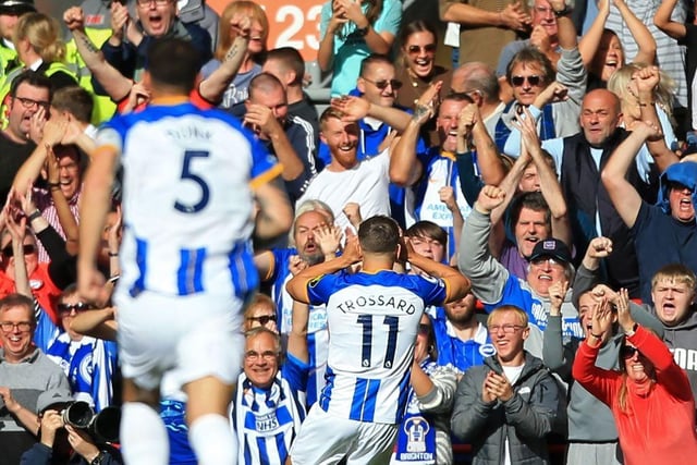 Brighton's Belgian midfielder Leandro Trossard (C) celebrates with fans after scoring the opening goal of the English Premier League football match between Liverpool and Brighton and Hove Albion at Anfield in Liverpool, north west England on October 1, 2022. (Photo by LINDSEY PARNABY/AFP via Getty Images)