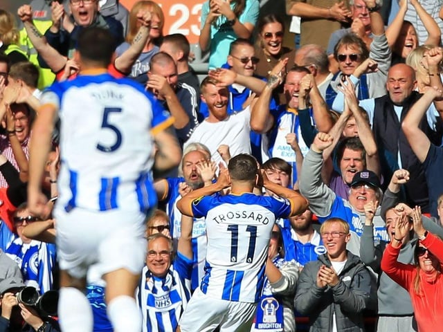 Brighton's Belgian midfielder Leandro Trossard (C) celebrates with fans after scoring the opening goal of the English Premier League football match between Liverpool and Brighton and Hove Albion at Anfield in Liverpool, north west England on October 1, 2022. (Photo by LINDSEY PARNABY/AFP via Getty Images)