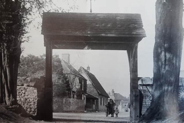 The view through the lychgate at St John the Baptist Church in Westbourne in the 1930s