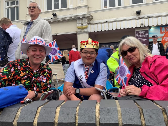 King Sam relaxes with his parents during the day's entertainment.