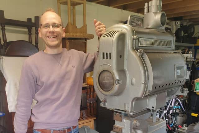 Christian Skelton with a vintage cinema projector that will be displayed in the Pavilion