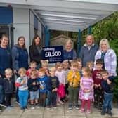 Staff and children of Thakeham Pre-School celebrate their new canopy with Bellway sales manager Fiona Mitchell, centre, left