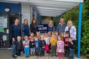 Staff and children of Thakeham Pre-School celebrate their new canopy with Bellway sales manager Fiona Mitchell, centre, left