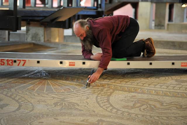 Dr Rob Symmons cleaning the mosaics at Fishbourne Roman Palace
