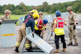 Emergency services practice putting up temporary flood barriers.