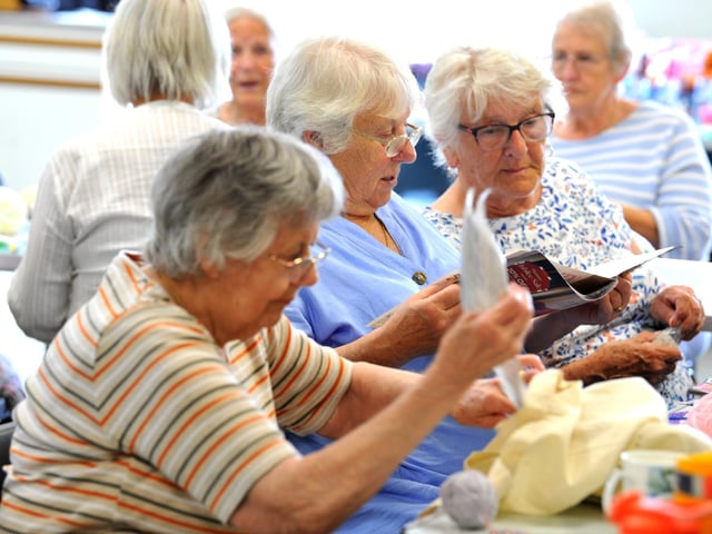 Arcade Knitters help each other with their projects, whether knitting, crocheting or sewing