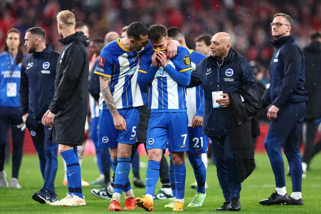 LONDON, ENGLAND - APRIL 23: Solly March is consoled by Lewis Dunk of Brighton & Hove Albion after missing the seventh penalty in the penalty shoot out during the Emirates FA Cup Semi Final match between Brighton & Hove Albion and Manchester United at Wembley Stadium on April 23, 2023 in London, England. (Photo by Clive Rose/Getty Images)