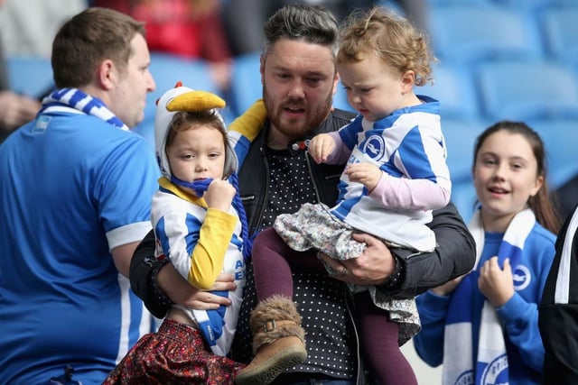 A Brighton and Hove Albion fan enjoys the pre match atmosphere with his children prior to the Premier League match between Brighton and Hove Albion and Southampton at Amex Stadium on October 29, 2017.