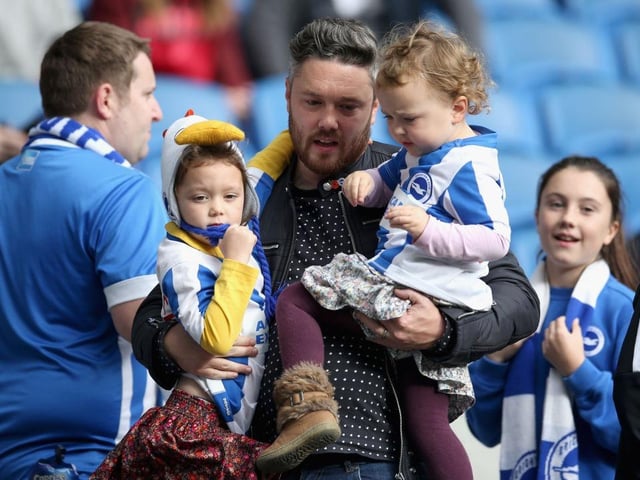 A Brighton and Hove Albion fan enjoys the pre match atmosphere with his children prior to the Premier League match between Brighton and Hove Albion and Southampton at Amex Stadium on October 29, 2017.