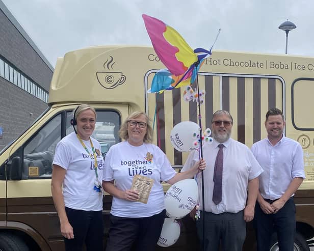 Morrisons' Littlehampton community champion Alison Whitburn, store manager Shaun Schofield and ops manager Kirk Jenson hand the butterfly to Coffees and Creams manager Elley for delivery to Worthing. Picture: Morrisons / Submitted