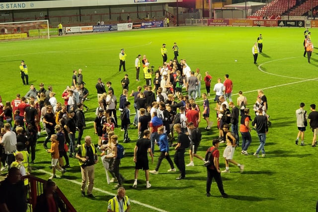 Crawley Town fans on the pitch at the end of the game
