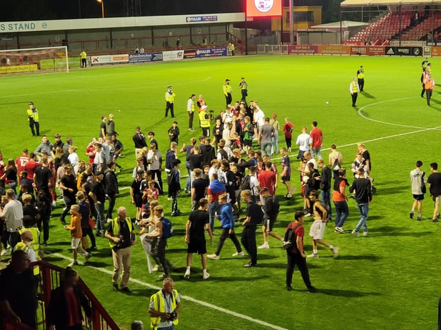 Crawley Town fans on the pitch at the end of the game
