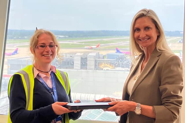 Nicole Ronaldson (London Gatwick Passenger Operations) receives a laptop from Melanie Wrightson (London Gatwick Stakeholder Engagement Manager)