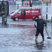 Shopkeepers clear drains in South Farm Road, Worthing. Picture: Eddie Mitchell