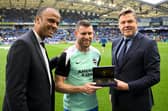 Maheta Molango, CEO of the Professional Footballers' Association, and Richard Masters, Chief Executive of the Premier League, awards James Milner an award in recognition of the most Premier League appearances. (Photo by Mike Hewitt/Getty Images)