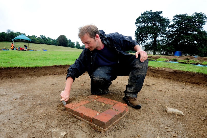 Tom Dommett, the National Trust archaeologist leading the project, with part of a building uncovered at The Big Dig in August 2015