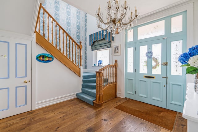 There is an entrance hall with a feature staircase and wooden floors