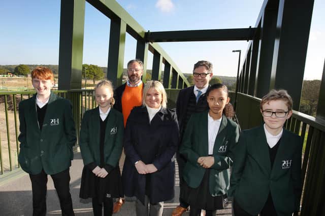James Blair, construction manager at the Mowbray development, Georgette Ayling, headteacher at Bohunt Horsham, and Jeremy Quin MP with pupils from the school