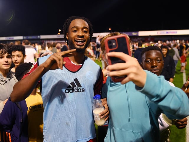 CRAWLEY, ENGLAND - AUGUST 23: James Balagizi of Crawley Town celebrates with fans following their side's victory in the Carabao Cup Second Round match between Crawley Town and Fulham at Broadfield Stadium on August 23, 2022 in Crawley, England. (Photo by Mike Hewitt/Getty Images)