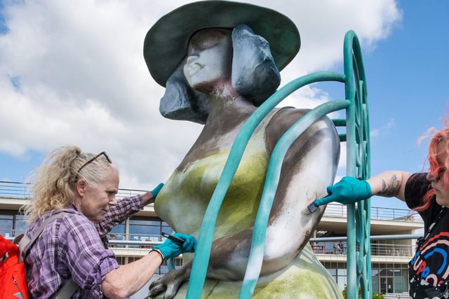 Volunteers help restore the sculpture. Picture by Lineker Photography