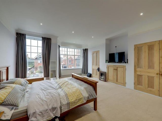 The primary bedroom has wardrobes and storage cupboards