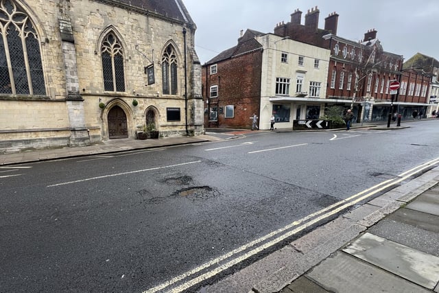 Wide angle view of the pothole on West Street in Chichester.