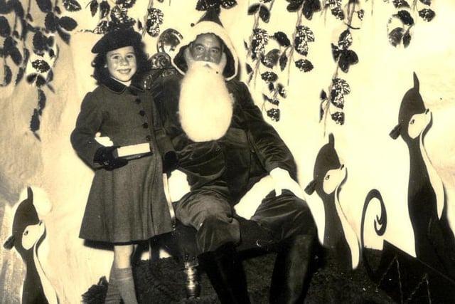 A young girl meets Santa at Bobby's department store, Terminus Road, in 1952.