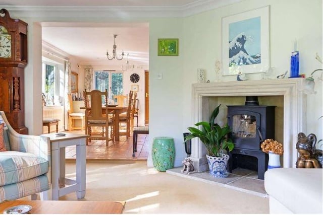 There is a stone fireplace in one corner of the sitting room, set with a woodburner.