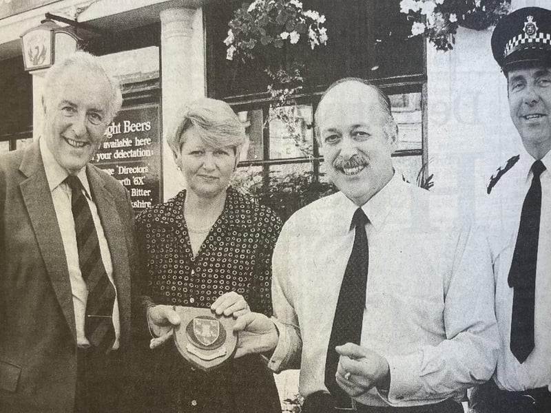 Sir Philip Ward, Lord Lieutenant of West Sussex and Chief Inspector Mike Parkes present a shield to the owners of The Alex in Bognor for helping on the night of the explosion.