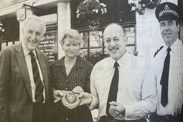 Sir Philip Ward, Lord Lieutenant of West Sussex and Chief Inspector Mike Parkes present a shield to the owners of The Alex in Bognor for helping on the night of the explosion.