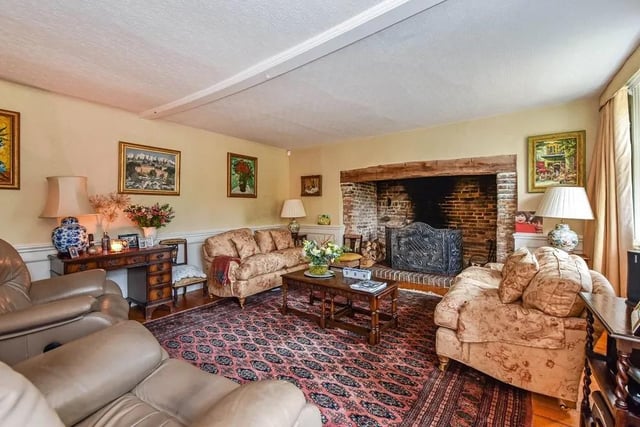There is a large drawing room with an impressive inglenook fireplace