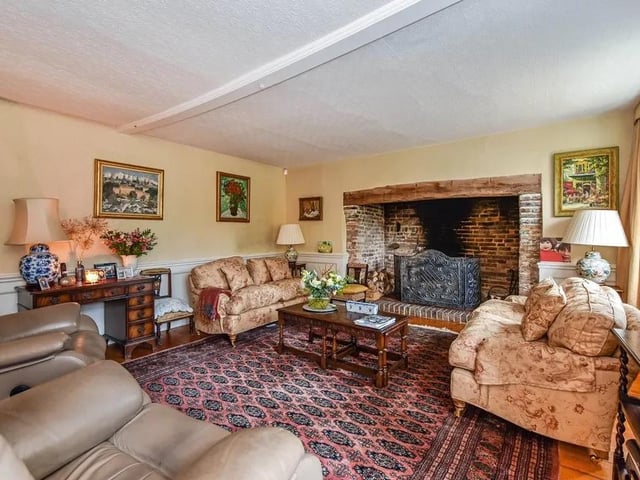 There is a large drawing room with an impressive inglenook fireplace