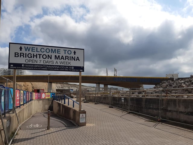 Go down the slope underneath the sign saying Welcome to Brighton Marina, a path that is shared by cyclists and pedestrians