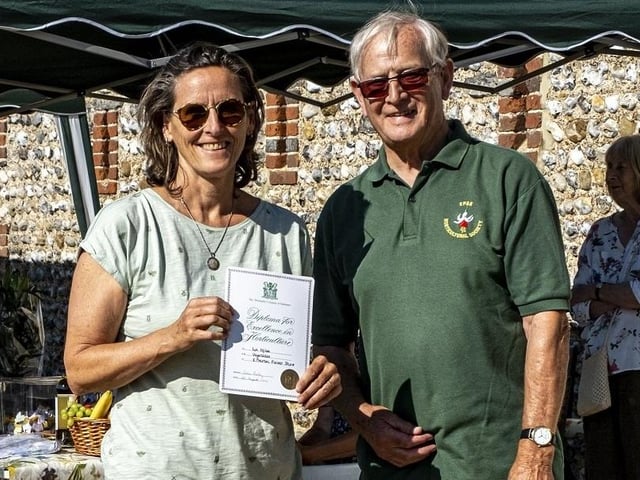 Liz Miles receives the Best Vegetable award from Colin Crane at East Preston and Kingston Horticultural Society flower show