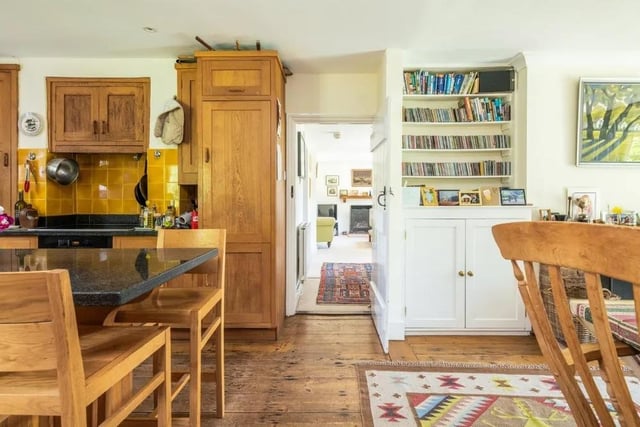 There is a large and well-appointed kitchen/reception/breakfast room, which has built-in bookcases, storage, and a fireplace