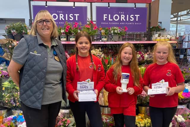 Alison Whitburn, community champion at Morrisons in Littlehampton, with Olivia, Lily Rose and Abigail