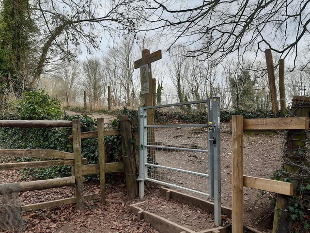 You will see a large metal gate ahead but you are best to take the small gate on the right before following the footpath up through the trees