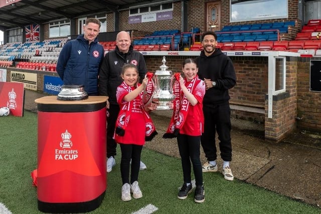 Sophia Paviour, aged 10 (front left) and Amelie Paviour, aged 12 (front right) with Eastbourne Borough's goalkeeper Lee Worgan, manager Danny Bloor and presenter Josh Denzel. Picture from Emirates